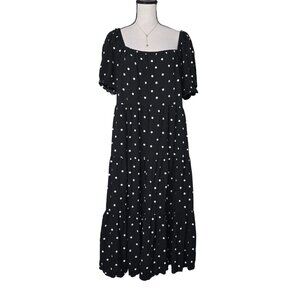 The black mid-length dress from the J.Crew brand, featuring a star pattern